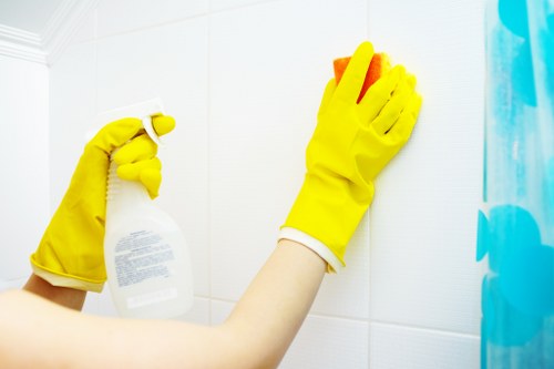 Trained cleaner using protective gear during a safe cleaning task